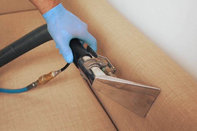 a man cleaning upholstery in wellington